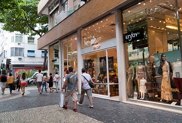 Rio de Janeiro, Brazil - March 17, 2012: Elegant and sophisticated shops in Leblon district. Pedestrians walk in the sidewalk.