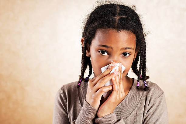 istock African American girl blowing her nose. 171296509