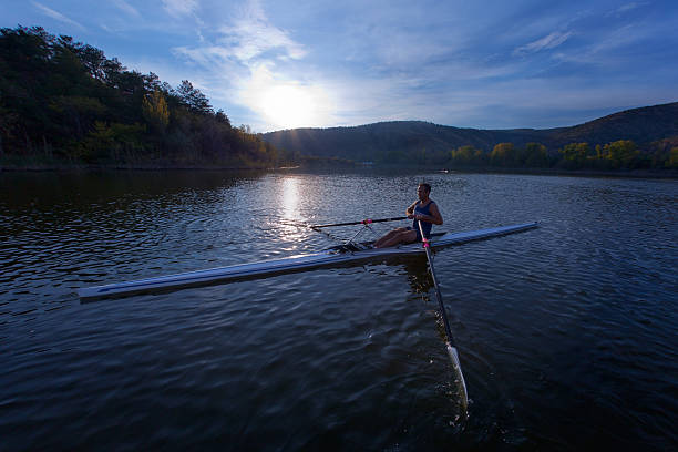 istock Adult Rower man rowing sculling boat on lake 171296708