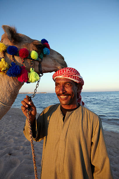 istock Happy Camel and owner by the sea 171297051