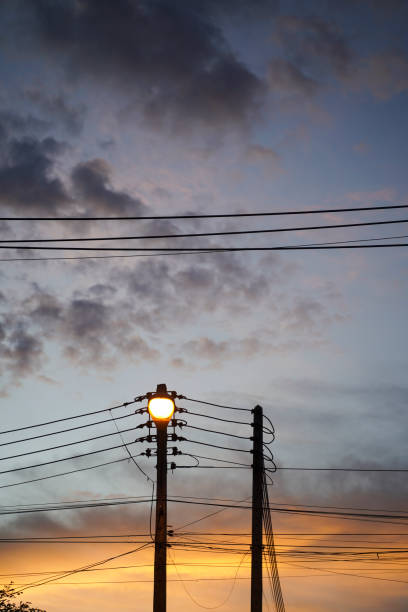 istock street lamp hanging on electricity pole with many cables. 1712972777