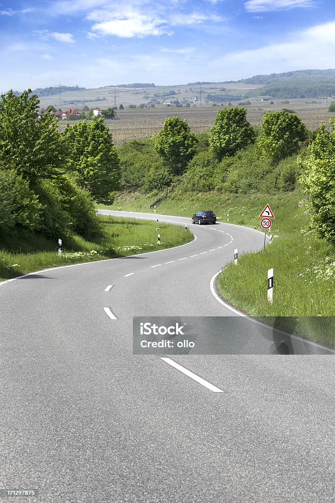 Country road, curve "Country road, curve and car. All identifiable logos, license plates and trademarks have been removed carefully" Car Stock Photo