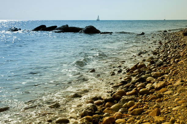 istock Sailing boat on calm Greek bay seashore foreground 171298189