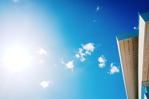 White business building with a colorful blue sky, space for copy text for advertisers.