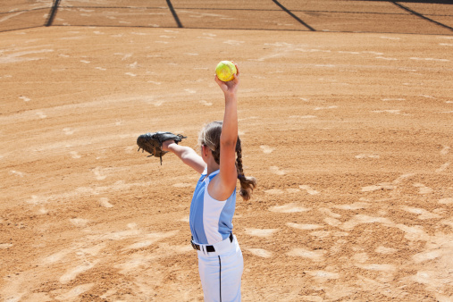 Left-handed fastpitch softball pitcher:  Girl (9 years) on mound.  Image shot from second base position looking in toward the plate.