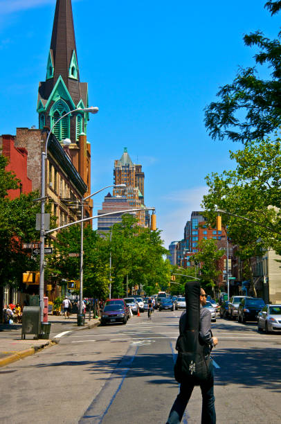 Cobble Hill Brooklyn, New York City Street scene & Cityscape "New York City, USA - June 03, 2012: A man with a guitar case is seen crossing Court Street in the Cobble Hill neighborhood of Brooklyn." warren street brooklyn stock pictures, royalty-free photos & images