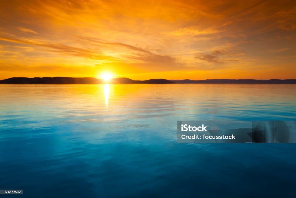 Sunset over water Balaton lake - Hungary Sunset Stock Photo