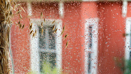 Rain drops from the window of the house