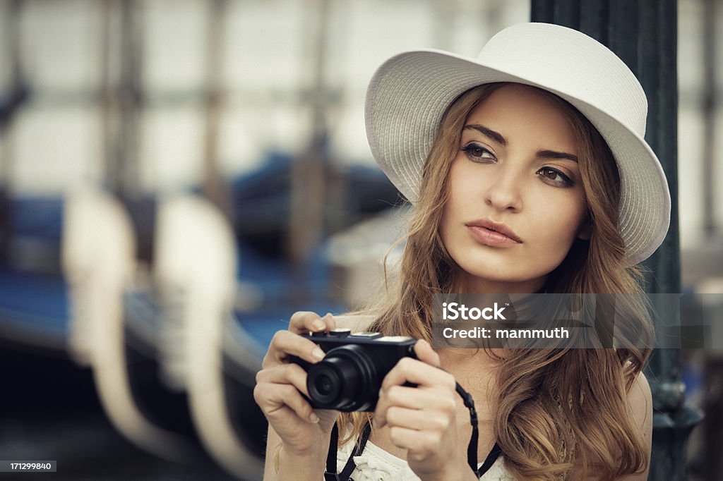 young tourist in Venice young tourist holding camera in Venice Sun Hat Stock Photo