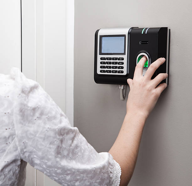 Fingerprint scan security door lock at use stock photo