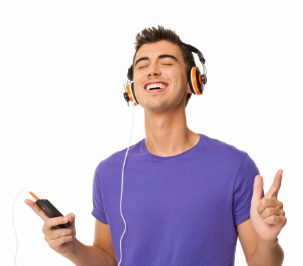 Happy young man in casual t-shirt listening music on cell phone with eyes closed. Horizontal shot. Isolated on white.