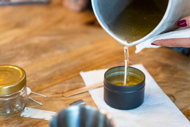 istock Aromatic candle workshop. Woman pouring melted soy wax. 1713008374