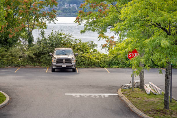 Beacon Station, Hudson Valley, New York, USA - August 14th 2023:  Parking lot behind the railway station with a single car and the Hudson River
