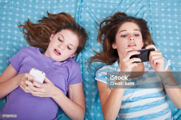 Girls Texting Stock Photo - Download Image Now - Pre-Adolescent Child, Text Messaging, 12-13 Years