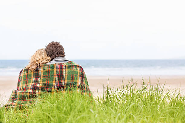 istock Couple Wrapped In Blanket At Beach 171301195