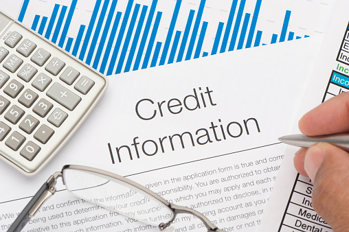 Credit information form with writing hand