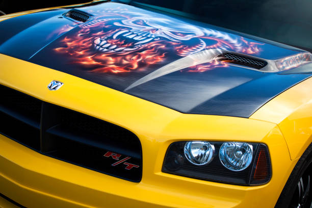 Dodge Charger RT "Dartmouth, Nova Scotia, Canada - June 28, 2012: In a parking lot, a close-up view of a Dodge Challenger RT with a custom painted hood.  Custom hood is similar to stock Dodge Challenger hood with faux air intakes on both sides.  The RT version features a 5.7 liter Hemi V8.  This generation was manufactured from 2006-2010." dodge charger stock pictures, royalty-free photos & images