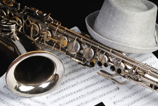Close up of Saxophone with Sheet Music and Hat