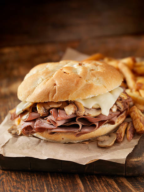 Mushroom and Swiss Ham Sandwich "Ham Sandwich with Mushrooms, Swiss Cheese and Fries- Photographed on Hasselblad H3D2-39mb Camera" curly fries stock pictures, royalty-free photos & images