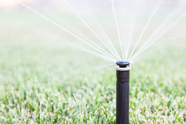 Sprinkler Sprinkler watering yard agricultural sprinkler stock pictures, royalty-free photos & images