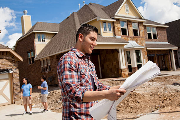 istock Builder in foreground with buyers background at new home construction 171302585