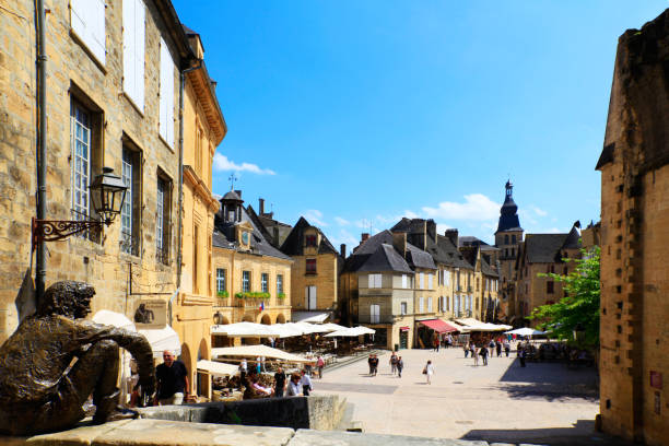 Sarlat "Sarlat, Spain - June 16, 2012:Sarlat has remained preserved and one of the towns most representative of 14th century France. It owes its current status on France's Tentative List for future nomination as a UNESCO World Heritage site to the enthusiasm of writer, resistance fighter and politician Andr!AA> Malraux, who, as Minister of Culture (19601969), restored the town and many other sites of historic significance throughout France. The centre of the old town consists of impeccably restored stone buildings and is largely car-free." sarlat la caneda stock pictures, royalty-free photos & images