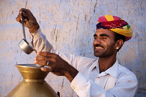 Portrait of Indian street seller selling tea- masala chai. Masala chai is a beverage from the Indian subcontinent made by brewing tea with a mixture of aromatic Indian spices and herbs.http://bem.2be.pl/IS/rajasthan_380.jpg