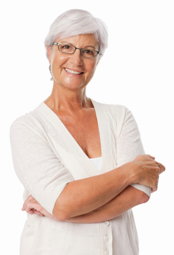 Portrait of a senior woman in spectacles smiling with arms crossed. Vertical shot. Isolated on white.