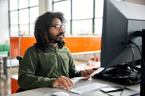 istock Mid adult businessman working at computer 1713032250