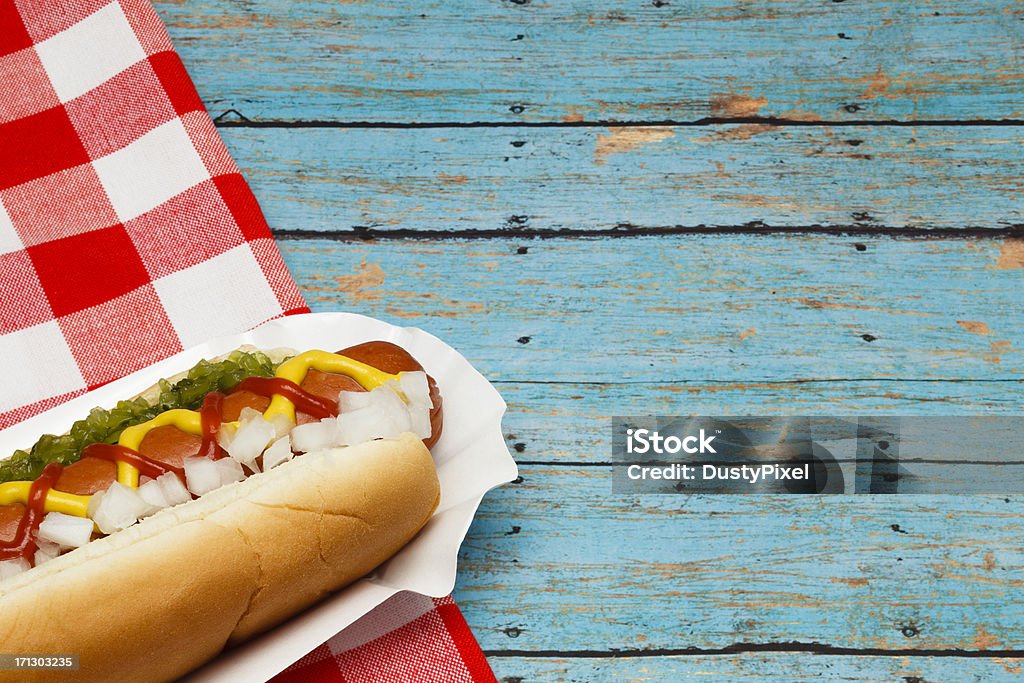 Picnic Hotdog Ketchup, mustard, relish and onion on a hot dog Blue Stock Photo