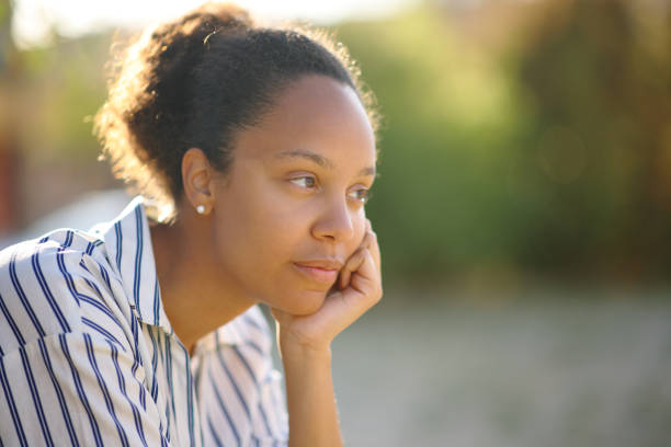 istock Black woman contemplating in a park 1713034414