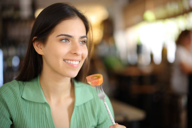 istock Happy customer eating tomato in a restaurant 1713036094