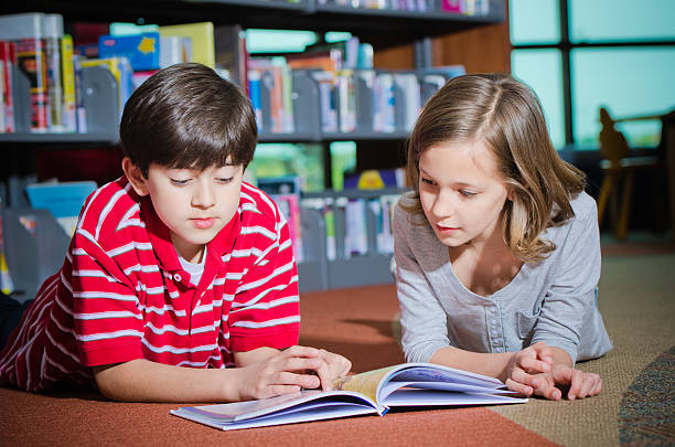 istock Happy Kids Reading Together In Library 171303894