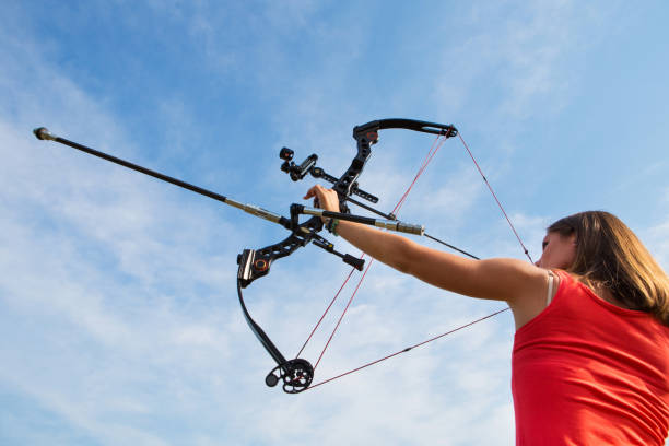 istock Young woman with bow and arrow aiming high 171303898