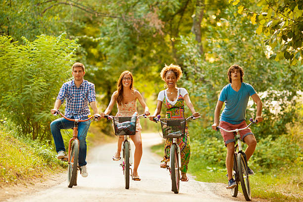 istock Two Couples Riding Bicycles in a park 171304186