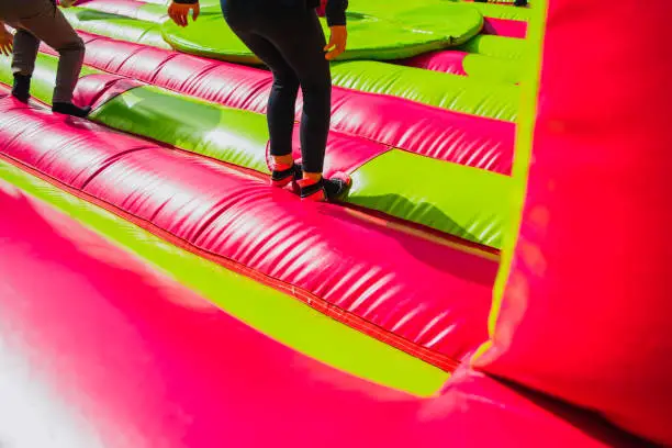 Girl jumping and exercising while having fun in an inflatable castle to bounce.