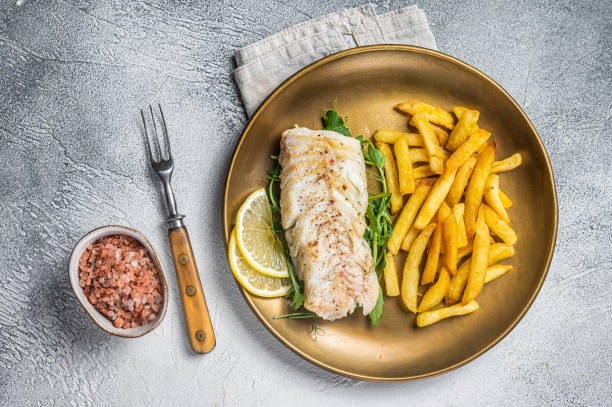 istock Fried cod fish fillet served with french fries. White background. Top view 1713046221