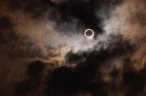 Annular solar eclipse, photographed in May 2012. The sun can be seen through the gaps in the clouds.