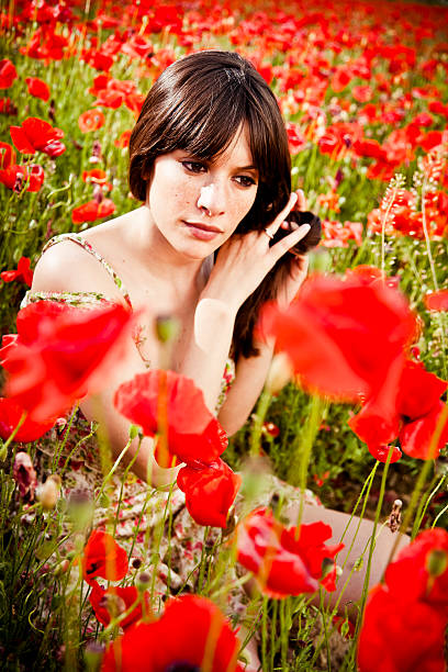 istock Young beauty in poppy field at sunset 171305255