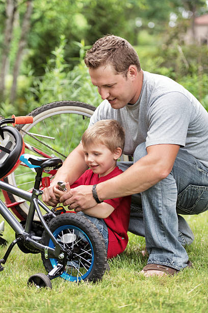 istock Dad and son repairing bike 171305920