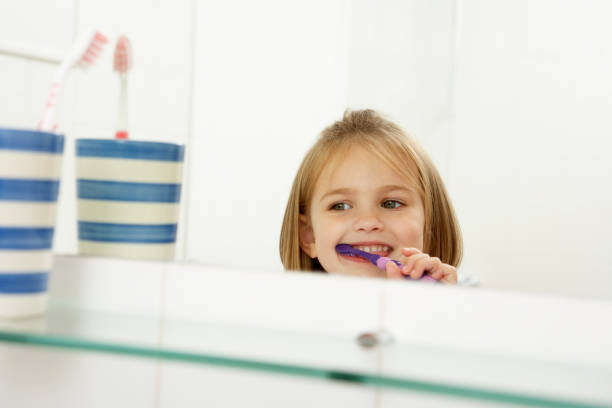 istock Girl In Bathroom Brushing Teeth 171306004