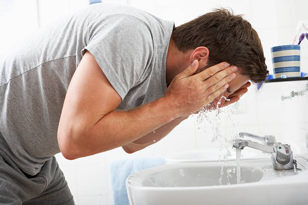istock Man Washing Face In Bathroom Sink 171306011