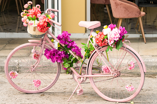 Classic pink bicycle decorated with flowers. High quality photo