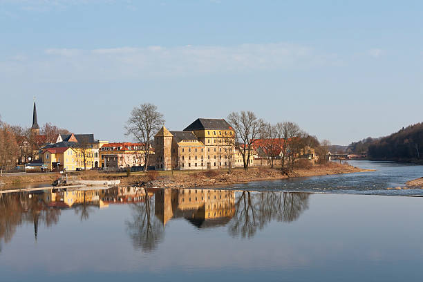 View to the town Grimma, Germany. "View to the town Grimma, Germany in the morning light in early springtime. Grimma is a small town in Saxony, situated on the river Mulde. Grimma is a famous Renaissance town with gothic buildings too. The abandoned factory in foreground is named Grossmuehle, an old water power station." grimma stock pictures, royalty-free photos & images