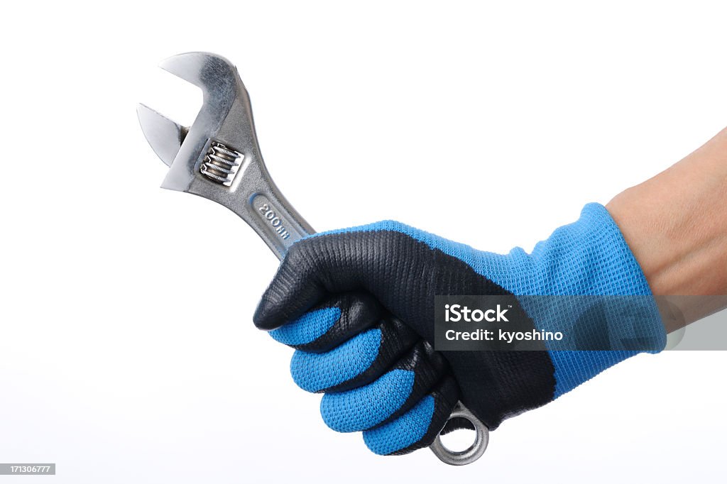 Isolated shot of holding a wrench on white background "Holding a wrench, isolated on a white background.Studio shot." Wrench Stock Photo