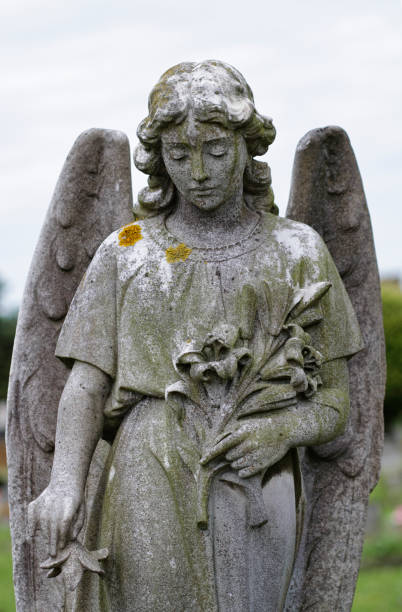 istock Guardian angel in stone holding flowers 171307301