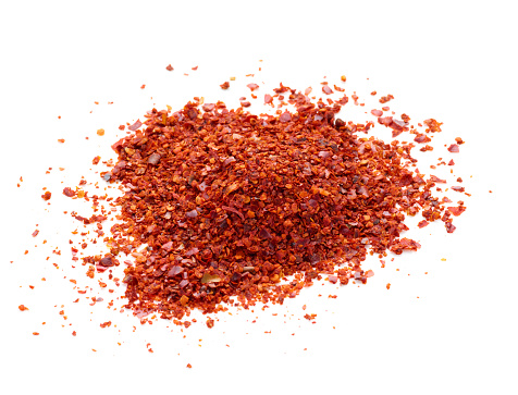 Crushed red pepper heap isolated on white background
