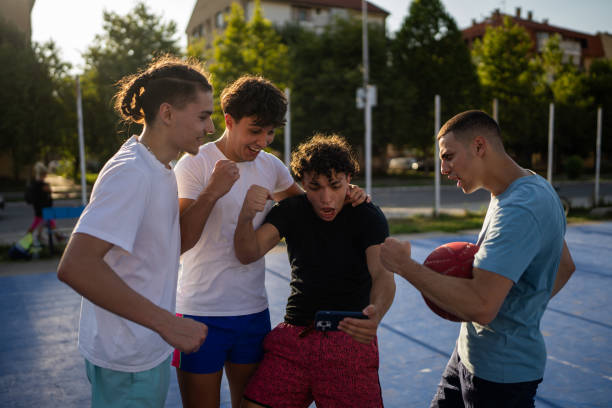 istock Men watching a match on smart phone 1713081458