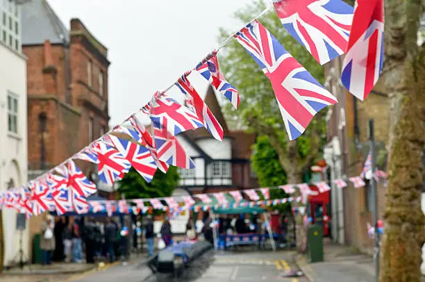 Royalty free stock photo of Union Jack flags bunting in local street party.See