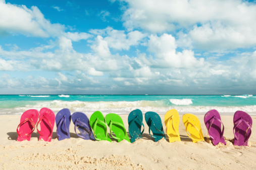 Subject: Spring break flip flops vacationing on the sandy beach of the Caribbean Sea.